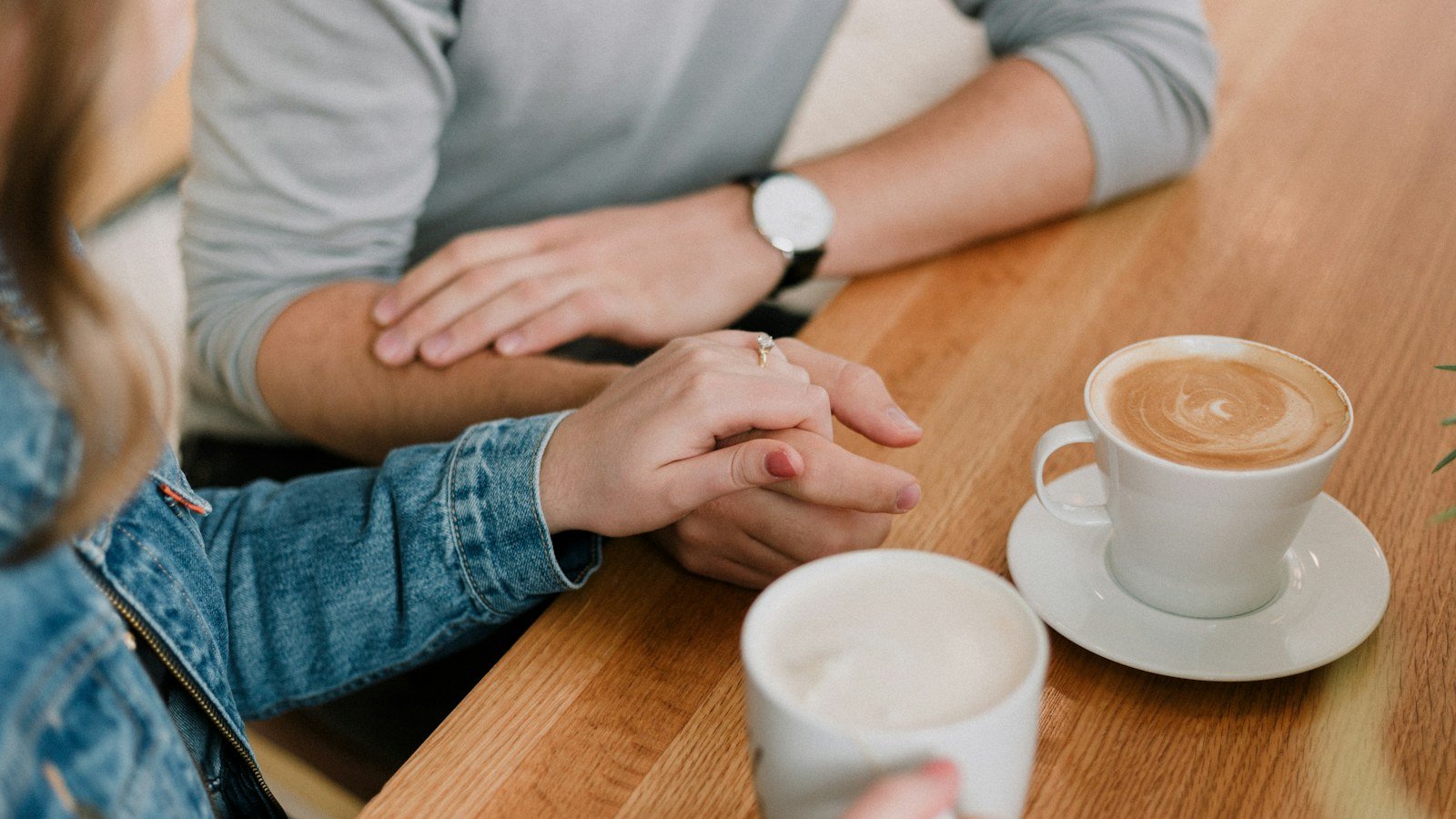 A couple holding hands while discussing whether their relationship can be repaired