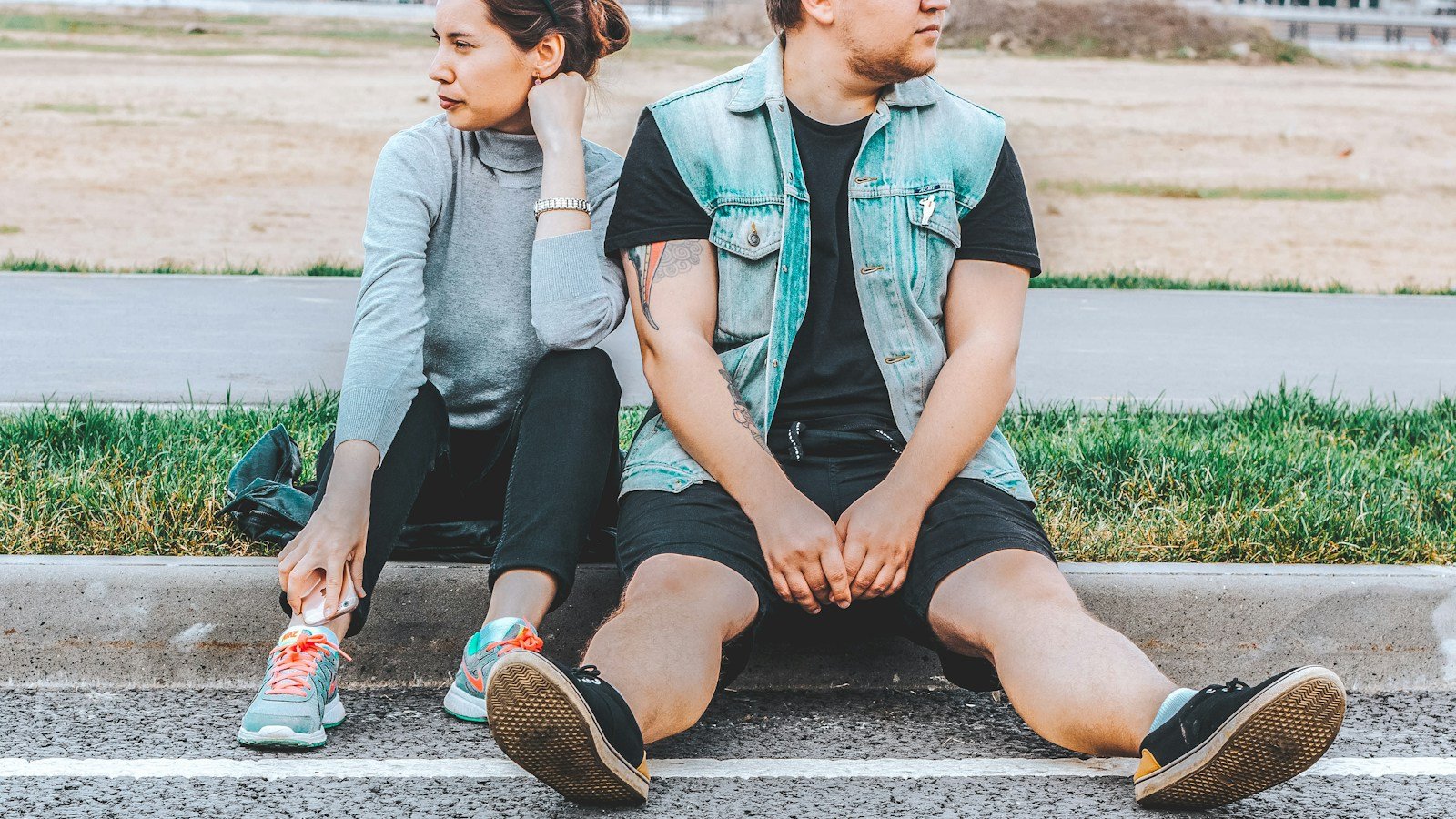 Couple sitting apart while considering whether to continue their relationship after infidelity